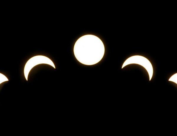 A minimalist depiction of solar eclipse phases captured in a crescent pattern on a dark background.